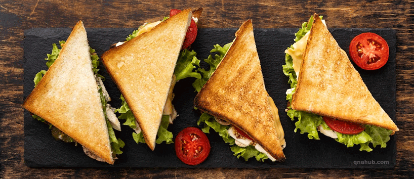 triangle-sandwiches-on-a-slate-with-tomato